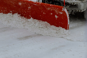 Snow removal tractor clears the road after heavy snowfall.