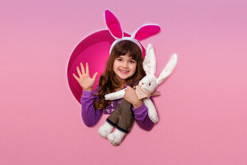 Obraz na płótnie Canvas Cute little girl with Easter bunny ears holding 