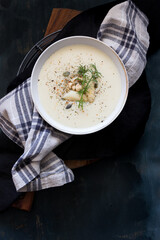 Bowl of Asparagus soup on a squared napkin.