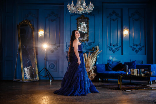 Beautiful Woman In A Blue Ball Gown And Blue Room