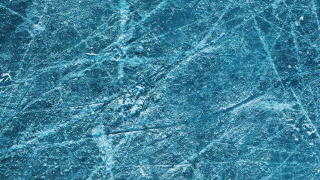 Rotating texture of ice on a skating rink. View from above.