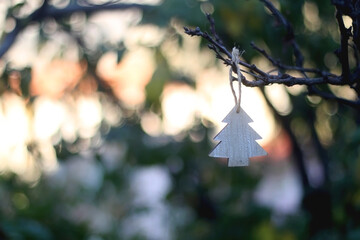 Christmas tree ornament hanging in the garden. Selective focus.