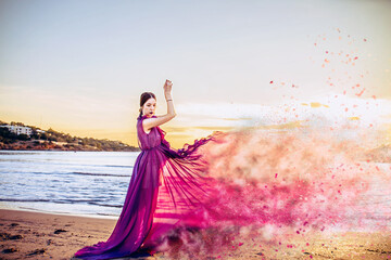 Woman in purple  Flying Dress with disperse dust effect  Fluttering on Wind, Girl in Waving Gown on Sundown Sea 