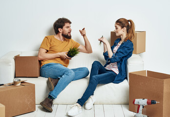 Fototapeta na wymiar Cheerful young couple in an apartment boxes with things moving 
