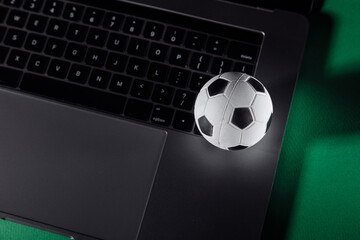 Soccer ball on a laptop's keyboard. Sport, gambling, money win concept.