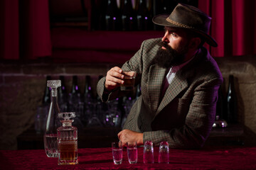 Alcoholic drinking in despair. Alcohol abuse, drunk man looking at a glass of whiskey.