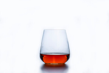 a glass of whiskey on a white background