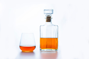 bottle and glass of whiskey on white background