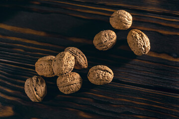 Walnuts on the Dark Brown Wooden Background
