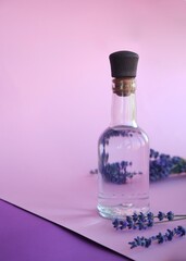 Natural aromatic lavender water - hydrolat and a bouquet of lavender flowers.

