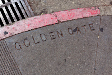 Shabby sidewalk corner of Golden Gate and Leavenworth in San Francisco's Tenderloin district.
