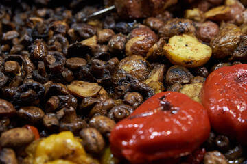 Kebabs, fried meat, potatoes, zucchini, mushrooms, peppers in the roasting pan