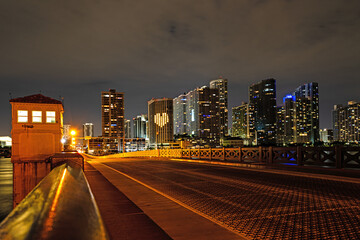 Fototapeta na wymiar Miami Florida, sunset panorama with colorful illuminated business and residential buildings and bridge on Biscayne Bay.