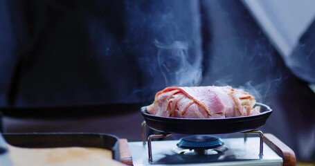 roasted bacon toast cheese in frying pan with smoke gas stove burning flame, breakfast food in the morning at campsite nature outdoors - Powered by Adobe