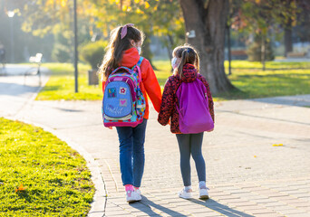A young mother, returning home from school with her daughters