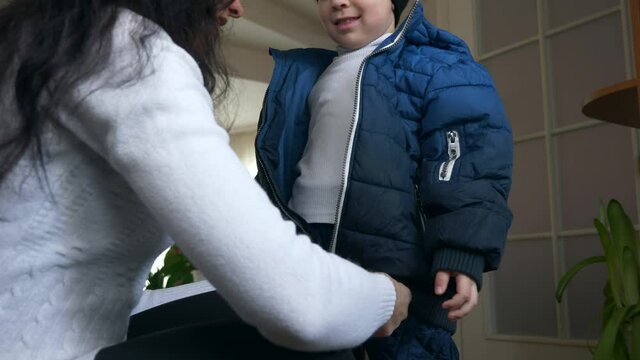 Mother Zipping her Sons Warm Waterproof Children Jacket. Little Child Boy Wearing Winter Attire. 2x Slow motion 60 fps 4K