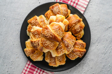 Close up on homemade cheese croissants in ceramic black plate on the marble table - homemade snack for breakfast - organic healthy traditional serbian food top view copy space