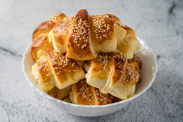 Close up on homemade cheese croissants in ceramic bowl on the marble table - homemade snack for breakfast - organic healthy traditional serbian food
