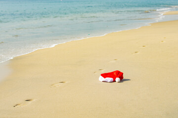 Santa Hat on the sea. Christmas and New Years vacation in hot countries.