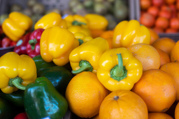Close-up picture of fresh organic vegetables and fruits placed mixed on a market stall 