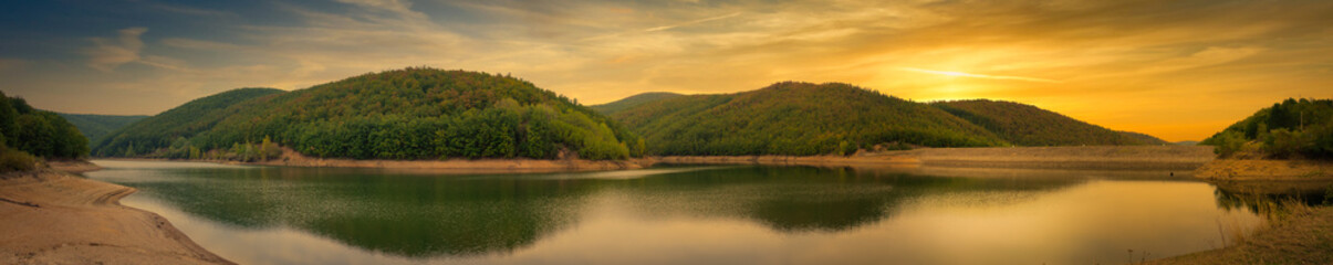 Amazing sunset scene over the small lake in south Alps.