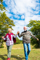 Senior couple on a walk in an autumn nature.
