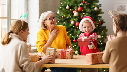 Cheerful relatives wrapping gifts together for Christmas