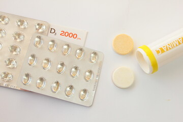 Vitamin D and C on a white background