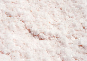 Close-up of crystals of pink salt on a salt lake. Salt background texture