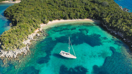 Yacht at private beach with deep turquoise clear waters