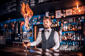 Professional bartender creates a cocktail in the night club