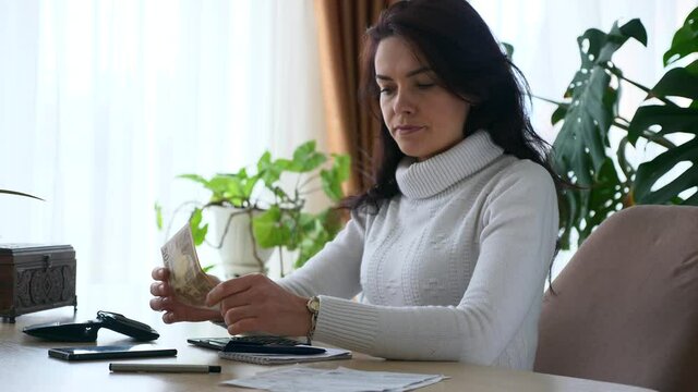 Woman Counting Money - Euro Cash while Working with Bills Taxes Planning Family Budget. Worried Mother Housewife at Office Table. 2x Slow motion 50 fps 4K