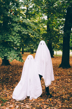 Children in ghost Halloween costumes