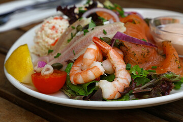 Cold and smoked seafood platter on wooden table