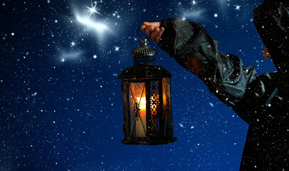 holding lantern on dark winter night © Melinda Nagy