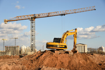 Excavator during earthmoving at construction site. Backhoe dig ground for the construction of...