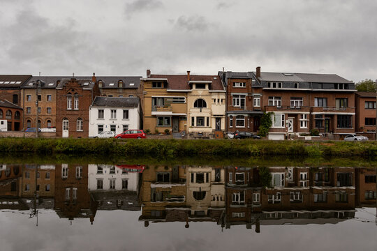 the city of Thuin and its reflection in the water of the river Samber
