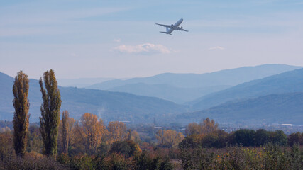 Fototapeta na wymiar Airplane above mountains.