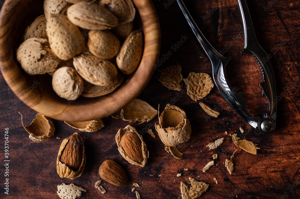 Wall mural almond in shell with nuts cracker