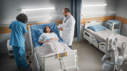 Hospital Ward: Friendly Latin Doctor Consulting Female Patient Resting in Bed. Physician Explains Test Results to Happy Woman Recovering after Successful Surgery. Nurse Checks Equipment. High Angle.