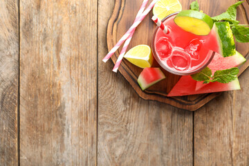 Delicious fresh watermelon drink on wooden table, top view. Space for text