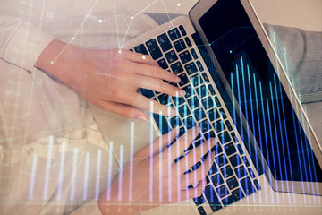 Double exposure of woman hands working on computer and forex chart hologram drawing. Top View. Financial analysis concept.