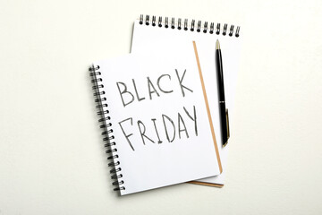 Notebook with phrase Black Friday on white background, flat lay