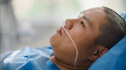 In Hospital Ward: Sick Man Lying on the Bed, His Head Nurse Hopefully Sits Beside Him Holds His Hand and Hopes for Recovery after Serious Surgery or Dangerous Disease. Close-up Emotional Shot.