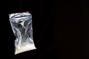 Fototapeta premium drug trap concept: drug bag with triple hook inside