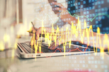 Multi exposure of woman hands typing on computer and financial graph hologram drawing. Stock market analysis concept.