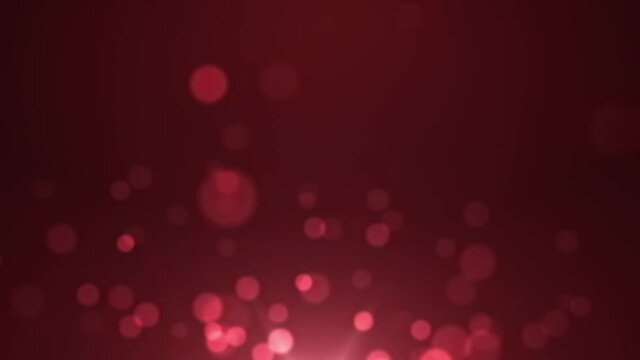 A burgundy motion background with blurred out shimmering and flickering circle bokeh rising up over a glowing light and disappearing into the atmosphere.