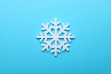 Fototapeta premium Beautiful decorative snowflake on light blue background, top view