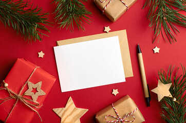 Christmas card mockup with gift boxes and pine tree branches