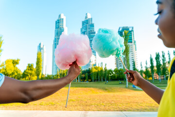 A happy black couple having colourful candy floss together